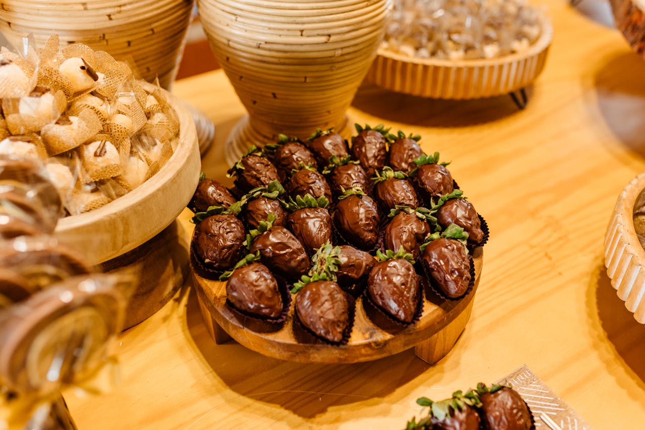 about-03 Chocolate-covered strawberries beautifully arranged on a wooden platter, perfect for dessert lovers.