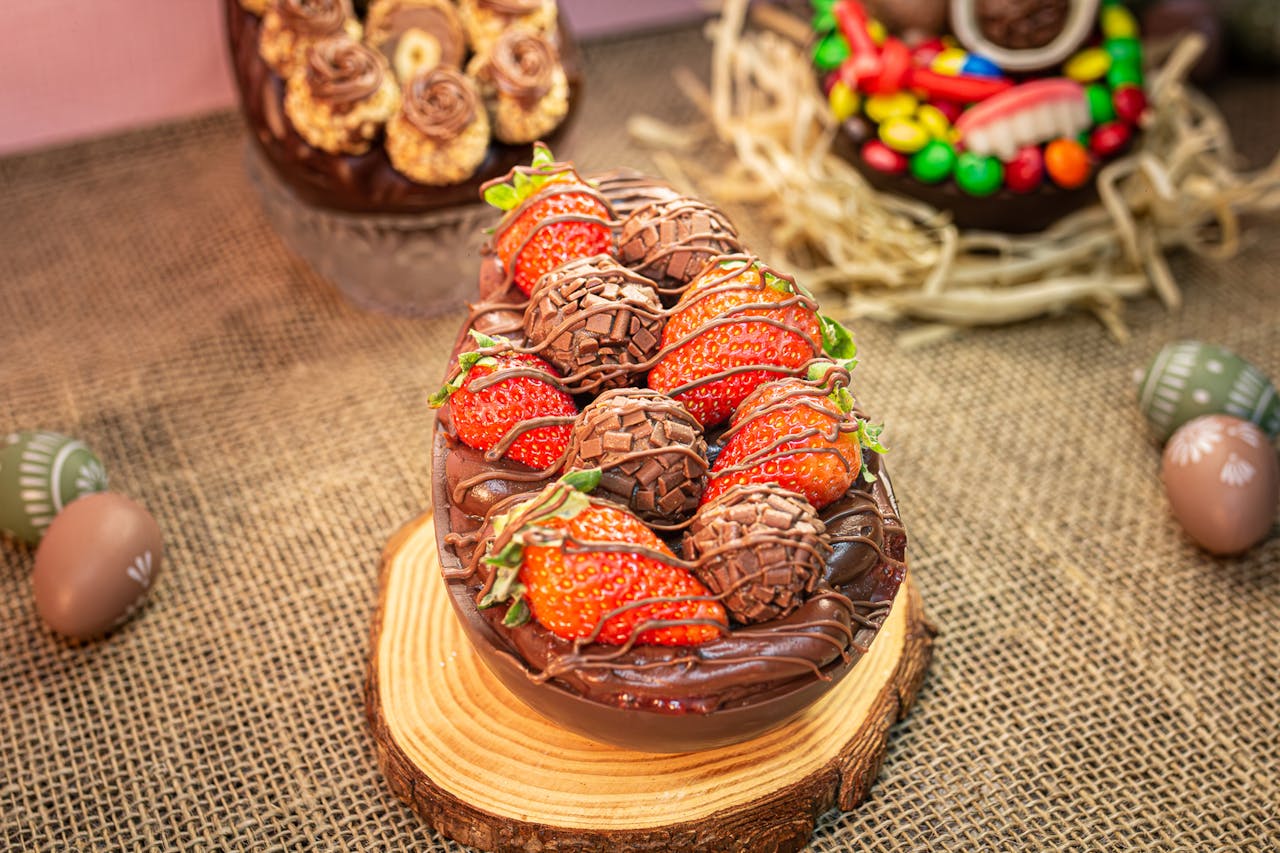 Gourmet chocolate Easter egg filled with strawberries and truffles, perfect for celebrations.